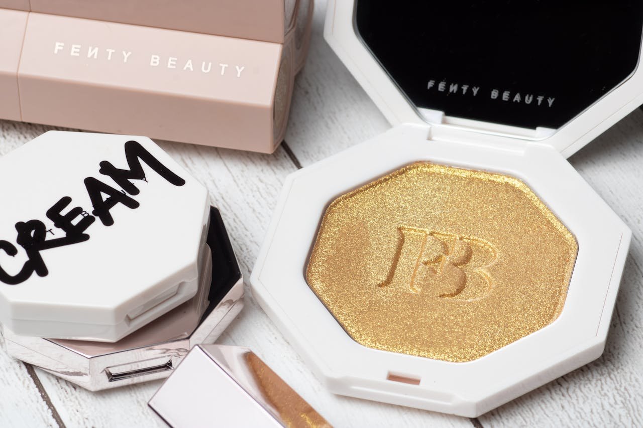 Stylish close-up of Fenty Beauty cosmetic products showcasing gold and elegant packaging.